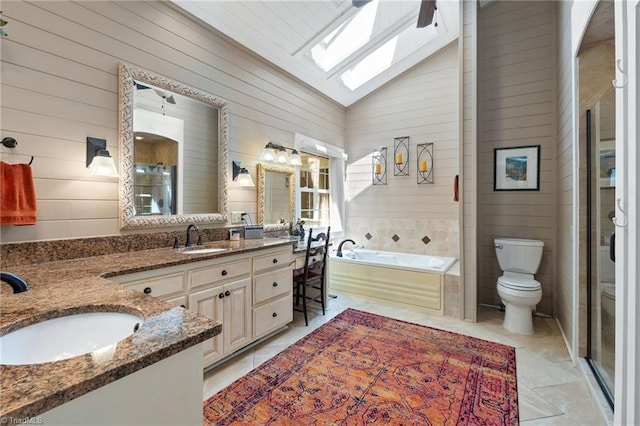3805 Tangle Oak Dr, Clemmons, NC 27012 - bathroom with double vanity, a bath, a stall shower, wooden walls, and a skylight