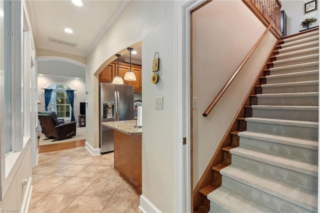 3805 Tangle Oak Dr, Clemmons, NC 27012 - stairway featuring arched walkways, crown molding, tile patterned flooring, and recessed lighting