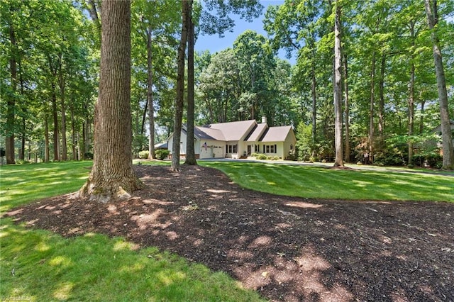 3805 Tangle Oak Dr, Clemmons, NC 27012 - view of front of home featuring a chimney, a front yard, and an attached garage