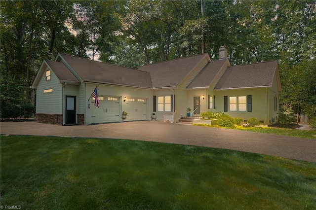 3805 Tangle Oak Dr, Clemmons, NC 27012 - view of front facade with a chimney, an attached garage, driveway, and a front lawn