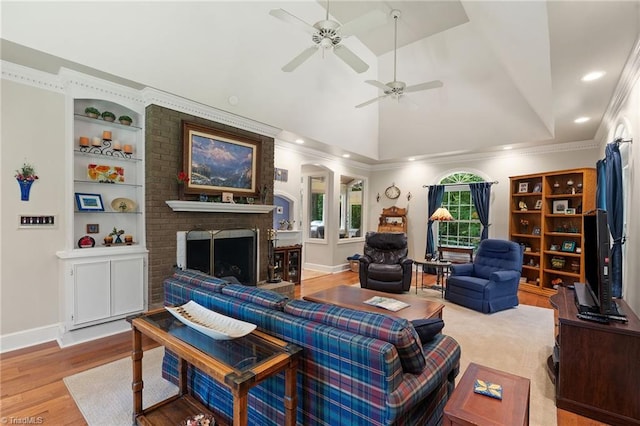 3805 Tangle Oak Dr, Clemmons, NC 27012 - living area featuring vaulted ceiling, a brick fireplace, a ceiling fan, wood finished floors, and recessed lighting