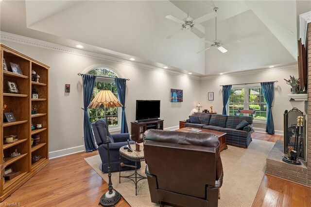 3805 Tangle Oak Dr, Clemmons, NC 27012 - living area with plenty of natural light, a ceiling fan, light wood-style floors, a fireplace, and high vaulted ceiling