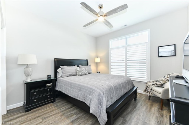 bedroom featuring baseboards, a ceiling fan, and wood finished floors