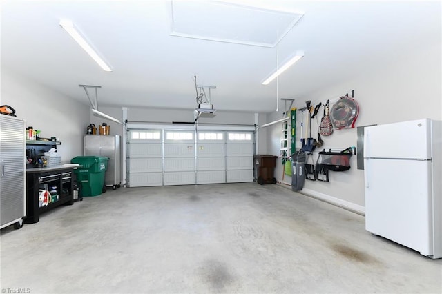 garage with a garage door opener and freestanding refrigerator