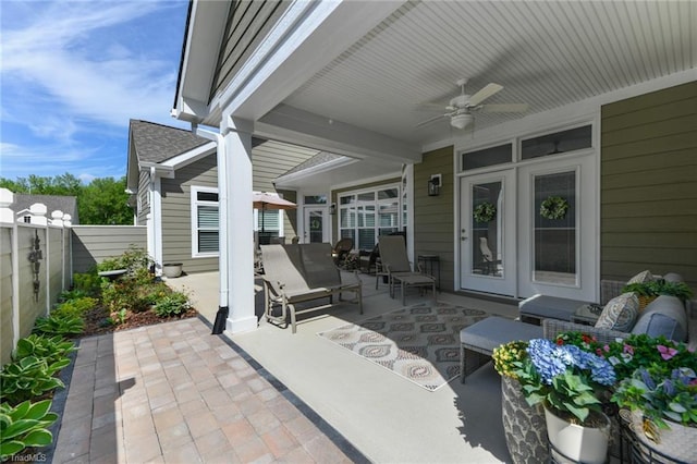 view of patio / terrace with fence and a ceiling fan