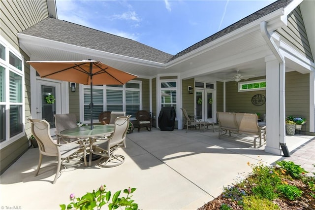 view of patio featuring outdoor dining area, ceiling fan, and french doors