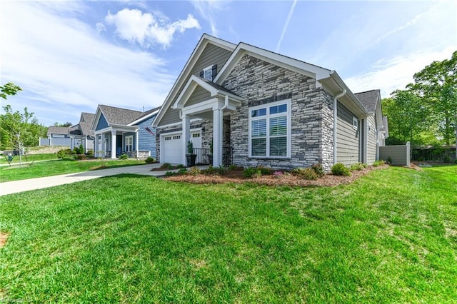 view of front of property with a front yard, fence, concrete driveway, an attached garage, and stone siding