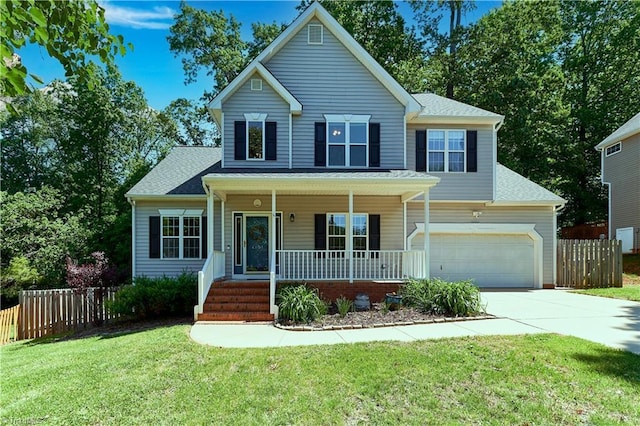 view of front of house with a front lawn, fence, covered porch, and concrete driveway