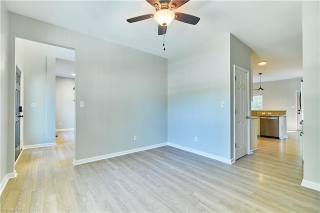 empty room featuring baseboards, a ceiling fan, and light wood-style flooring