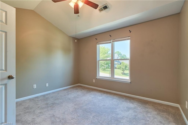 carpeted spare room featuring baseboards, ceiling fan, vaulted ceiling, and visible vents