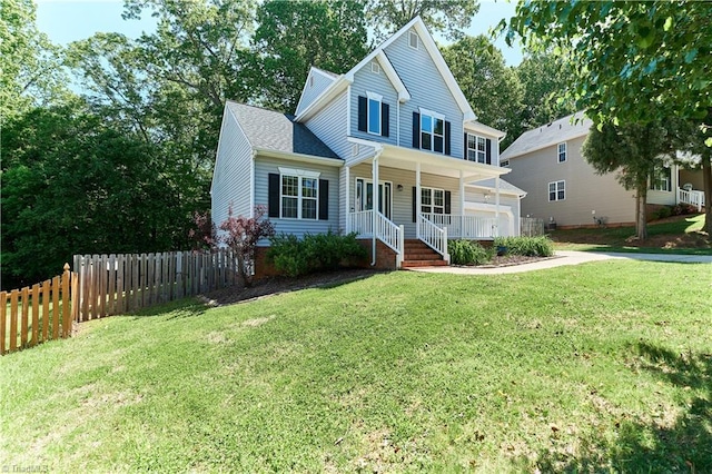 view of front of house with fence, covered porch, and a front yard