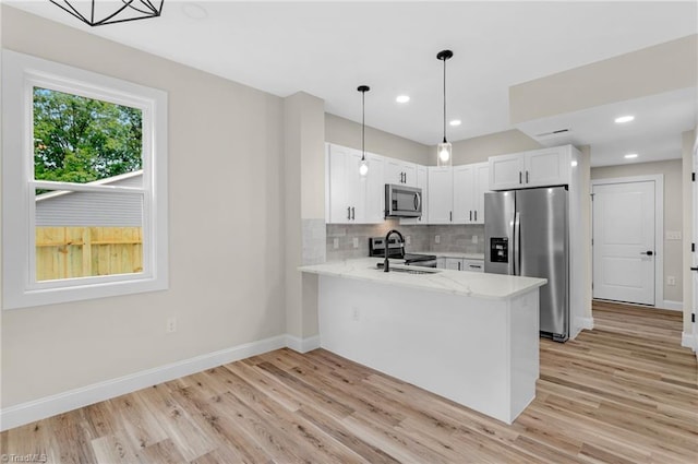 3630 Old Vineyard Rd, Winston-Salem, NC 27104 - kitchen with stainless steel appliances, light wood-style floors, a peninsula, baseboards, and recessed lighting