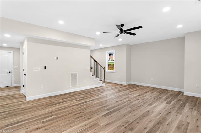 3630 Old Vineyard Rd, Winston-Salem, NC 27104 - unfurnished living room featuring light wood-style flooring, stairs, a ceiling fan, baseboards, and recessed lighting