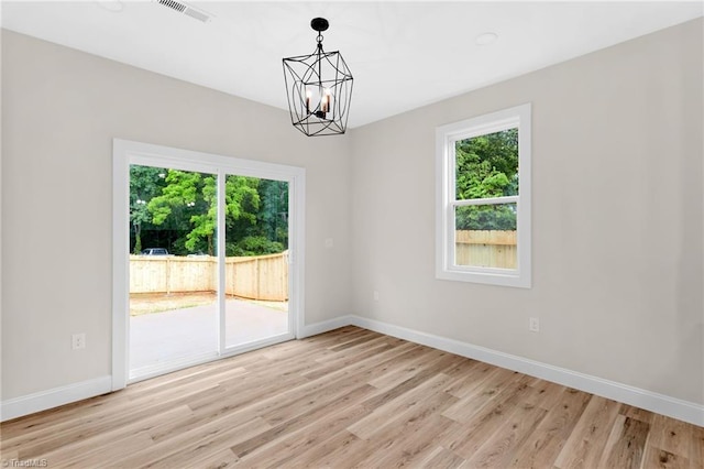 3630 Old Vineyard Rd, Winston-Salem, NC 27104 - unfurnished room featuring a chandelier, healthy amount of natural light, light wood finished floors, and baseboards