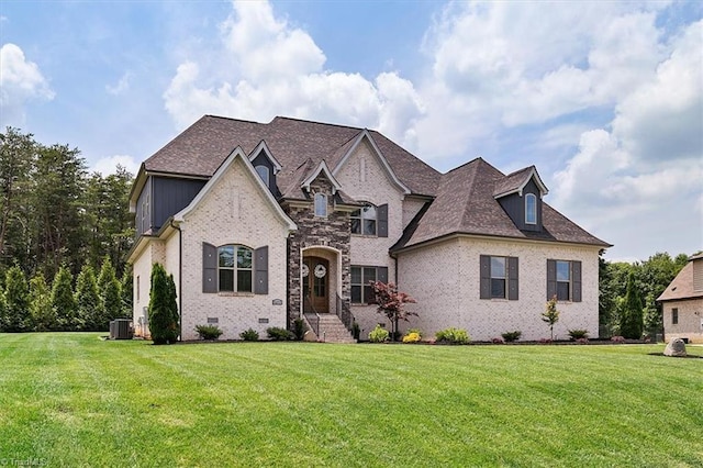 6203 Maggie Dixon Pl, Greensboro, NC 27455 - french country home with brick siding, central air condition unit, and a front lawn