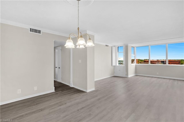 1101 N Elm St Unit 904, Greensboro, NC 27401 - unfurnished room featuring a chandelier, wood finished floors, baseboards, and ornamental molding