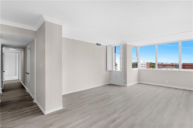 1101 N Elm St Unit 904, Greensboro, NC 27401 - empty room featuring crown molding, wood finished floors, and baseboards
