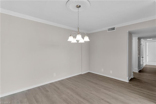 1101 N Elm St Unit 904, Greensboro, NC 27401 - spare room featuring wood finished floors, a chandelier, crown molding, and baseboards