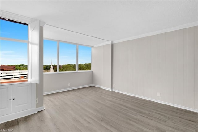 1101 N Elm St Unit 904, Greensboro, NC 27401 - unfurnished room with wood finished floors, crown molding, and baseboards