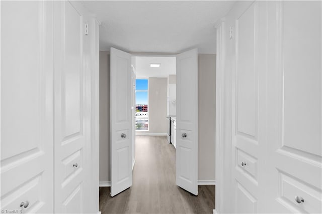 1101 N Elm St Unit 904, Greensboro, NC 27401 - hallway with dark wood finished floors, baseboards, and a textured ceiling