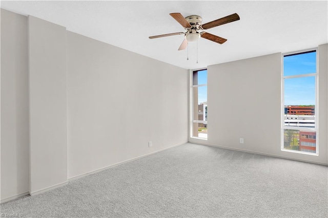 1101 N Elm St Unit 904, Greensboro, NC 27401 - carpeted spare room featuring a ceiling fan and baseboards