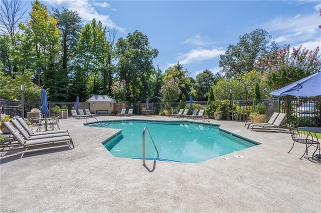 1101 N Elm St Unit 904, Greensboro, NC 27401 - community pool featuring a patio and view of scattered trees