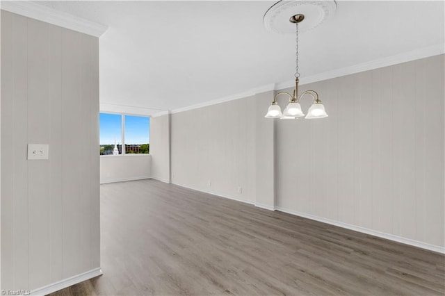 1101 N Elm St Unit 904, Greensboro, NC 27401 - unfurnished room featuring a chandelier, wood finished floors, ornamental molding, and baseboards