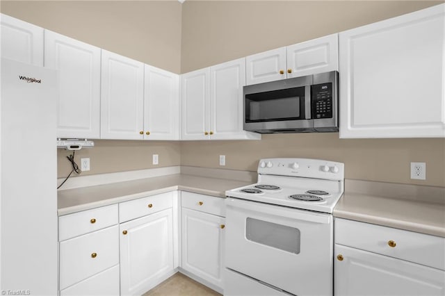 kitchen featuring white appliances, white cabinetry, and light countertops