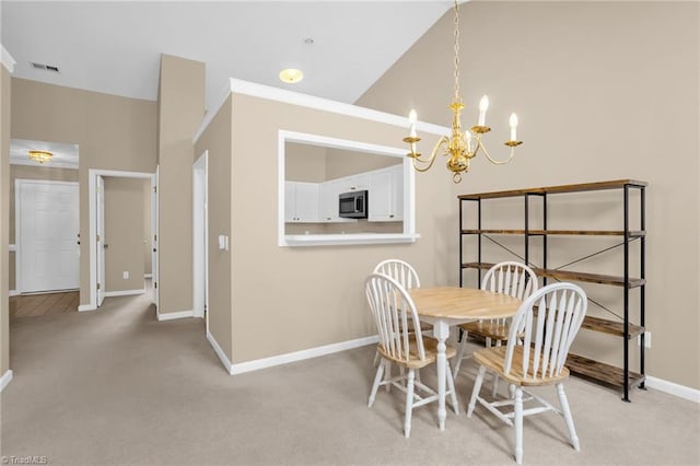 dining area featuring light carpet, a chandelier, baseboards, and high vaulted ceiling