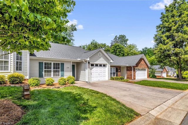 ranch-style house featuring a garage, driveway, a front yard, and roof with shingles