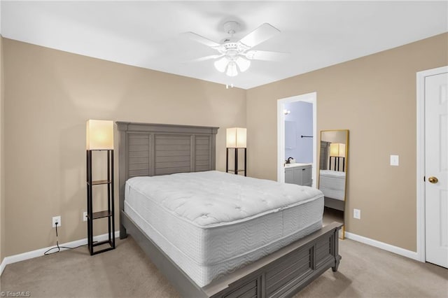 bedroom featuring light carpet, baseboards, a ceiling fan, and connected bathroom