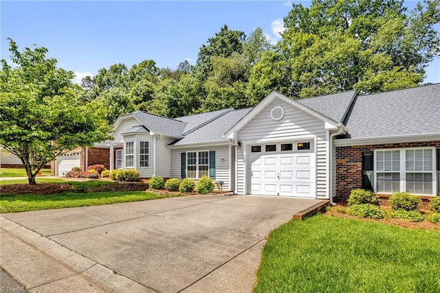 single story home with brick siding, a garage, concrete driveway, roof with shingles, and a front yard