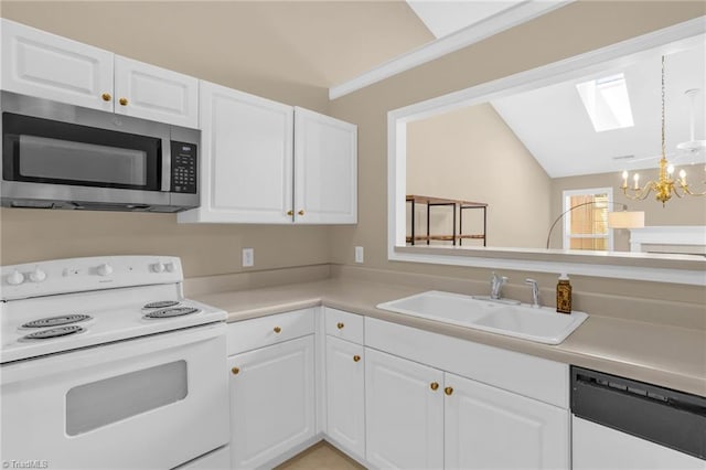 kitchen featuring electric stove, stainless steel microwave, dishwasher, lofted ceiling, and a sink