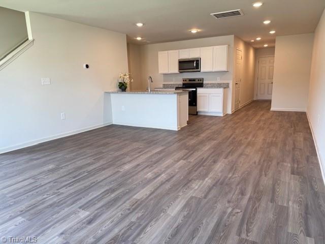 2210 Cranberry Way, Salisbury, NC 28147 - kitchen with appliances with stainless steel finishes, white cabinets, recessed lighting, dark wood-type flooring, and a peninsula