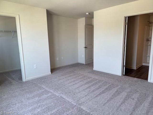 2210 Cranberry Way, Salisbury, NC 28147 - unfurnished bedroom with carpet floors, a walk in closet, and a closet