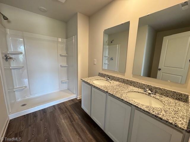 2210 Cranberry Way, Salisbury, NC 28147 - bathroom featuring wood finished floors, double vanity, and a shower