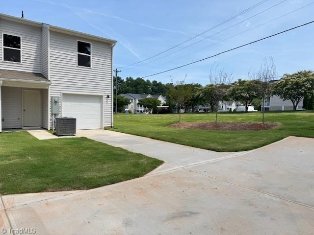 2210 Cranberry Way, Salisbury, NC 28147 - view of grassy yard featuring driveway and a garage