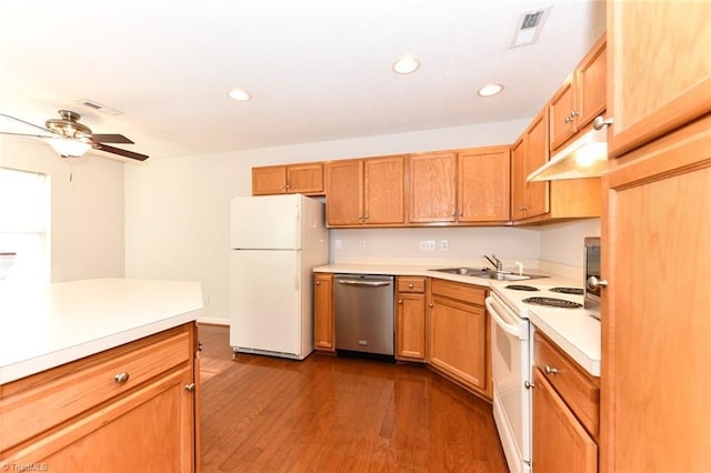 kitchen featuring dark wood-style flooring, light countertops, visible vents, a sink, and white appliances