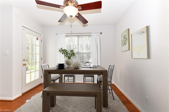 dining space with plenty of natural light and wood finished floors