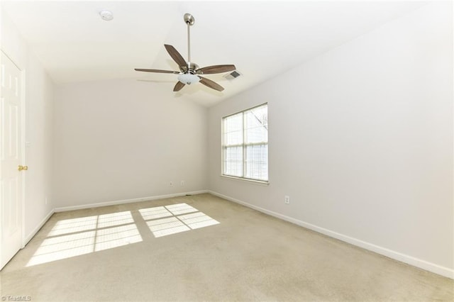 empty room with lofted ceiling, baseboards, light carpet, and visible vents