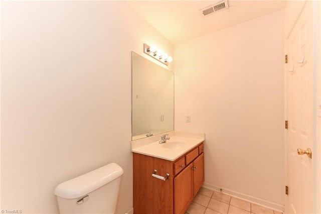 bathroom with tile patterned flooring, toilet, vanity, visible vents, and baseboards