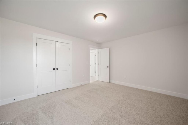 unfurnished bedroom featuring a closet and carpet flooring