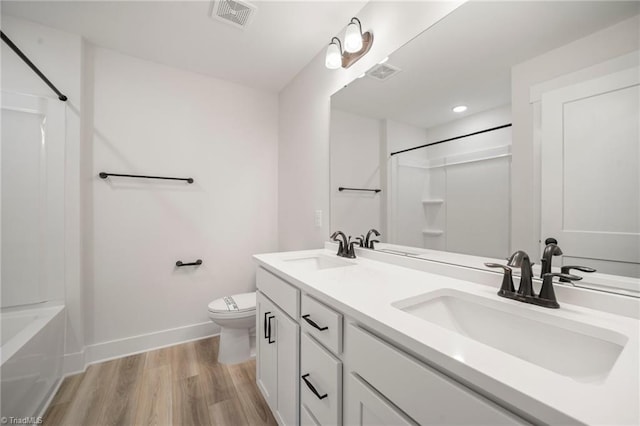 bathroom featuring wood-type flooring, toilet, and vanity