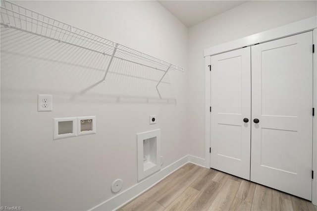 laundry area featuring light hardwood / wood-style floors, hookup for a washing machine, gas dryer hookup, and hookup for an electric dryer