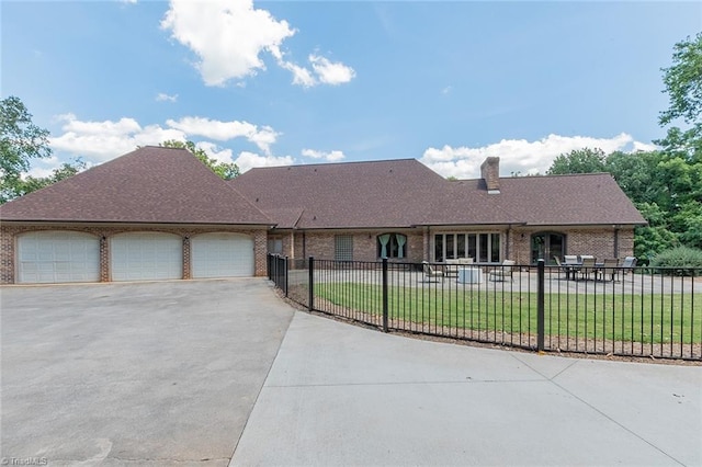 ranch-style house featuring a garage and a front yard