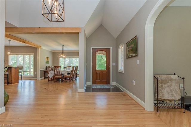 foyer entrance with vaulted ceiling and light wood-type flooring