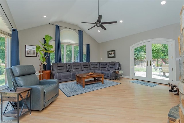 living room with lofted ceiling, light hardwood / wood-style floors, french doors, and ceiling fan