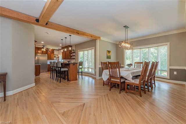 dining area featuring an inviting chandelier, beam ceiling, ornamental molding, and light parquet floors