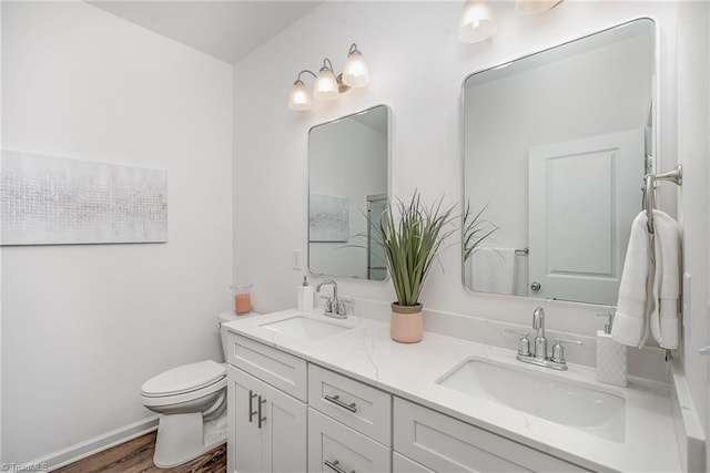 bathroom with vanity, hardwood / wood-style floors, and toilet