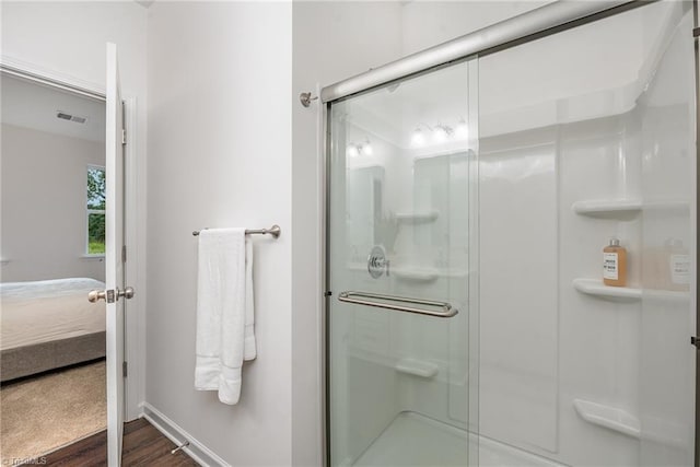 bathroom featuring wood-type flooring and walk in shower